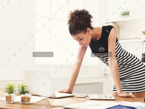 demo-attachment-115-business-woman-working-on-laptop-at-office-PRFJKQJ